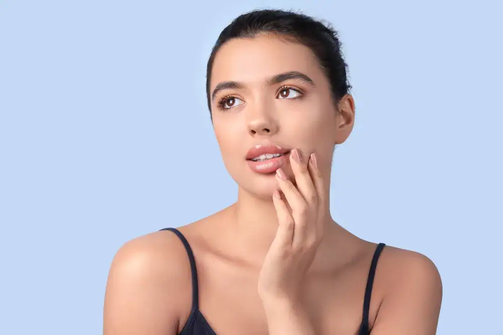 Woman in contemplative pose with hand on chin, gazing upward