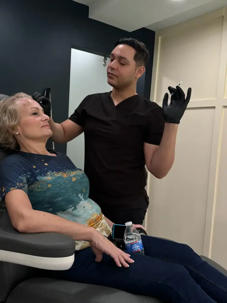 Doctor preparing a cosmetic injection for a patient in clinic.